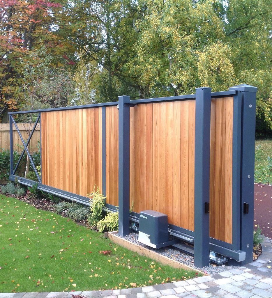 Timber-clad sliding gates like these for homes in Belfast